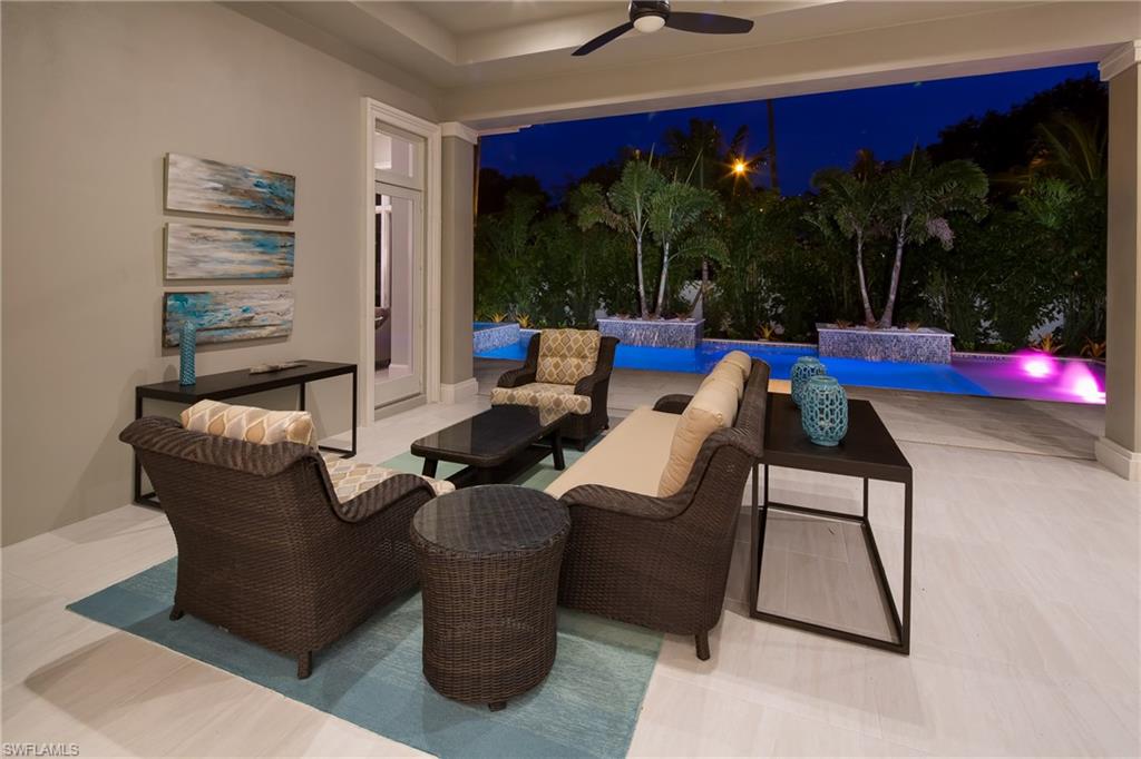 6818 Mangrove Avenue Naples, FL 34109 - Photo 16 of 24 a living room with patio furniture and garden