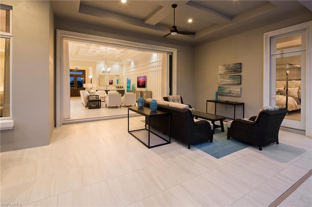 6818 Mangrove Avenue Naples, FL 34109 - Photo 17 of 24 a living room with furniture and a flat screen tv