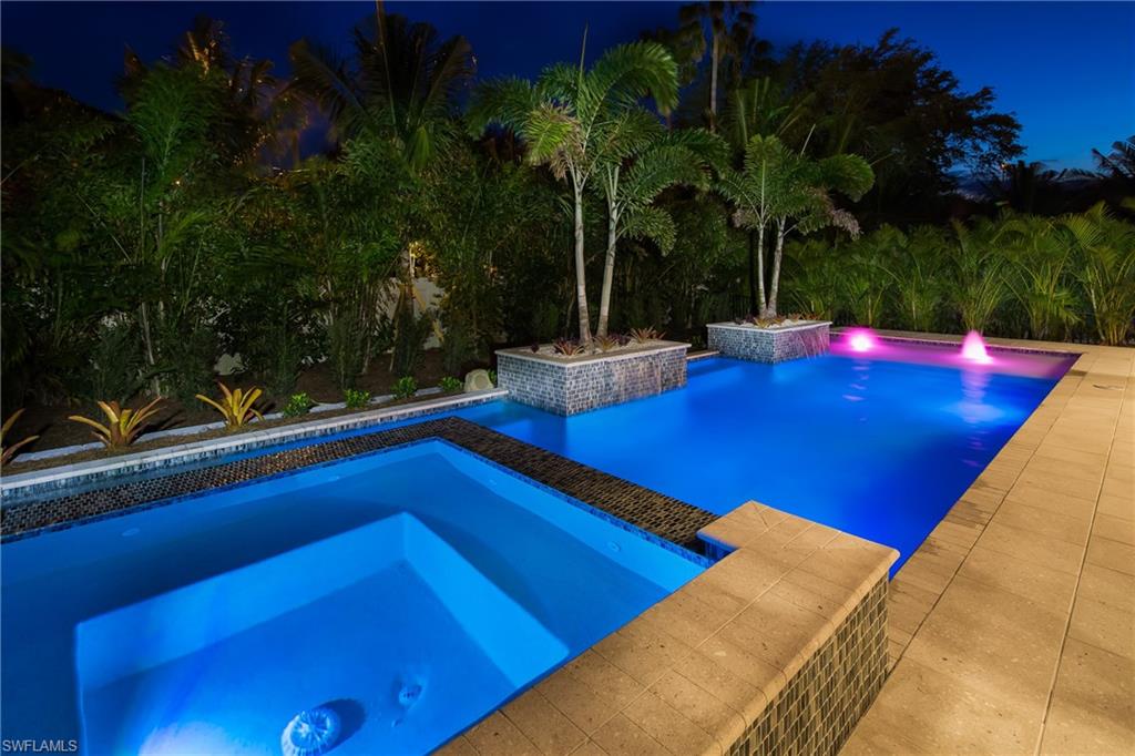 6818 Mangrove Avenue Naples, FL 34109 - Photo 20 of 24 a view of swimming pool with a patio and yard