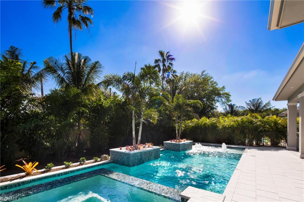 6818 Mangrove Avenue Naples, FL 34109 - Photo 24 of 24 a front view of a house with garden