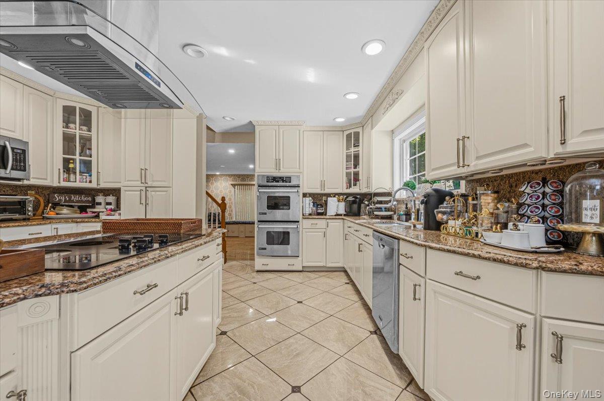 626 Caledonia Road Dix Hills, NY 11746 - Photo 17 of 49 a kitchen with granite countertop white cabinets and white appliances