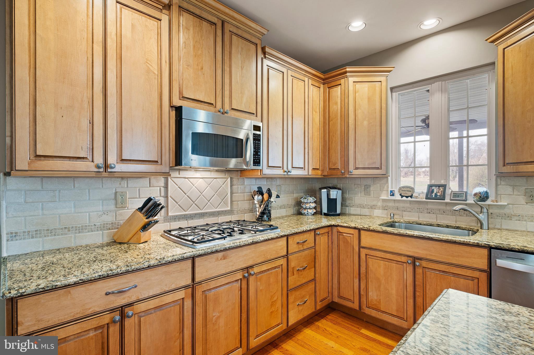 26 Woodside Farm Road Garnet Valley, PA 19060 - Photo 34 of 57 a kitchen with stainless steel appliances granite countertop a sink a stove and cabinets
