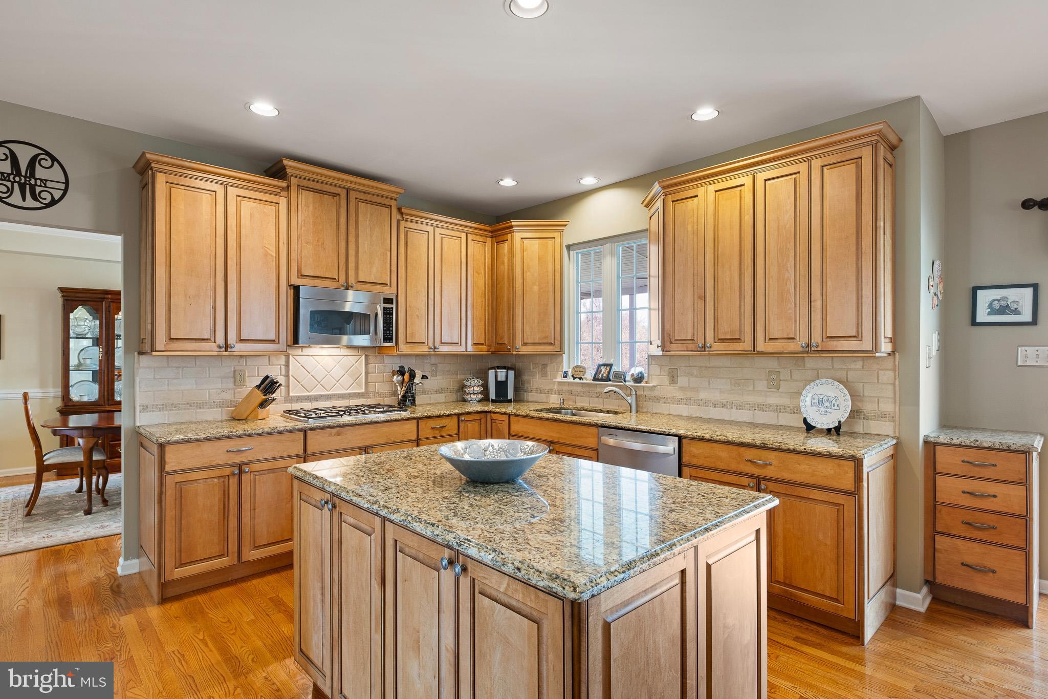 26 Woodside Farm Road Garnet Valley, PA 19060 - Photo 38 of 57 a kitchen with stainless steel appliances granite countertop a sink stove and cabinets