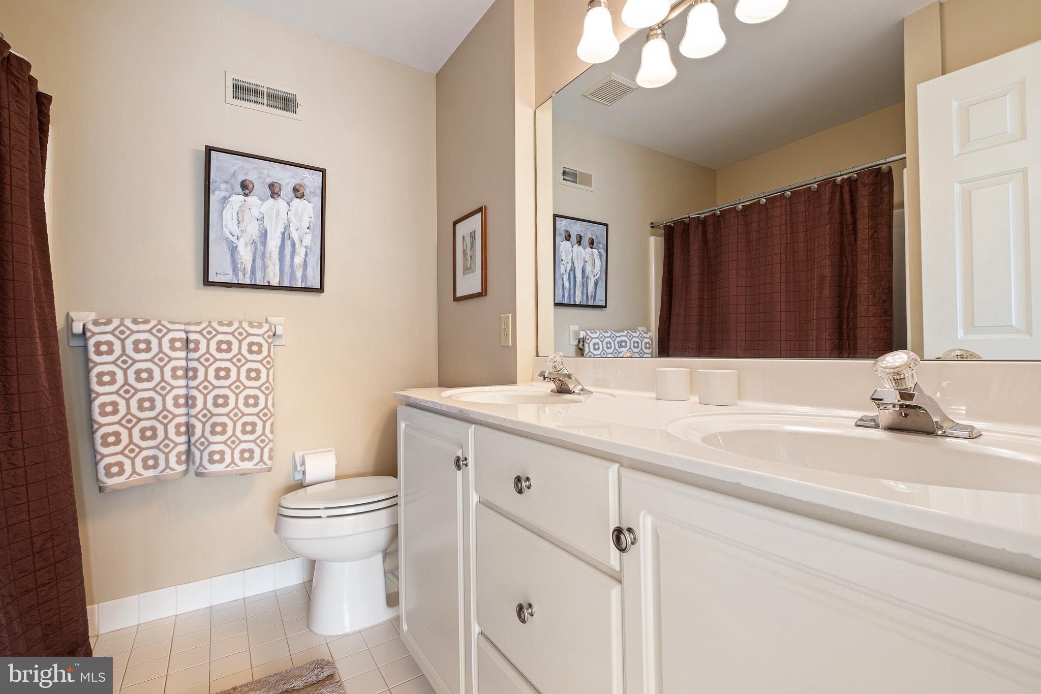 26 Woodside Farm Road Garnet Valley, PA 19060 - Photo 46 of 57 a bathroom with a toilet a sink and mirror