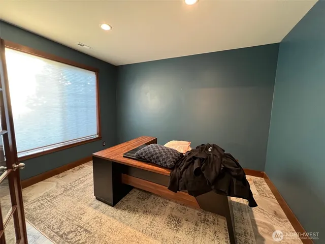 a bedroom with a bed and a window