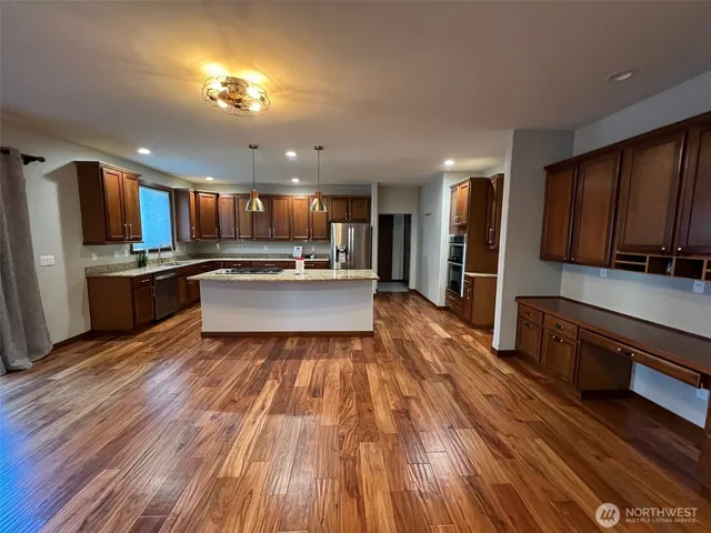 a view of kitchen with sink microwave and refrigerator