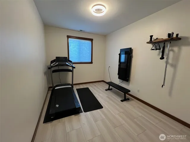 a room with gym equipment and windows