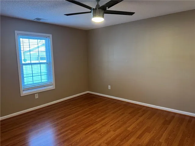 a view of a backyard with wooden fence