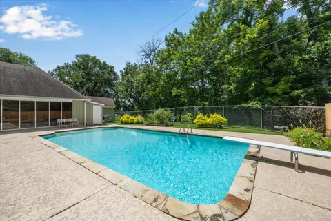 a view of a backyard with swimming pool