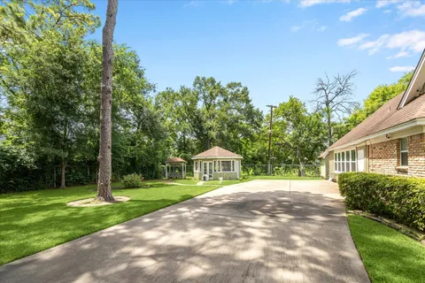 a front view of a house with a yard and trees