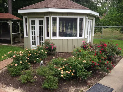 a view of a house with a flower garden