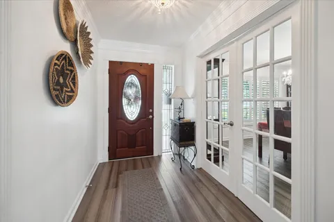 a view of a hallway with wooden floor and a window