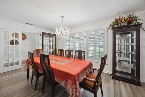 a view of a dining room with furniture and wooden floor