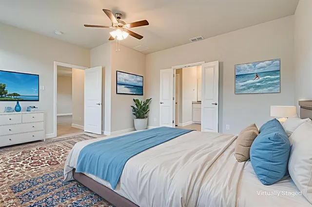 a bedroom with a bed and a chandelier