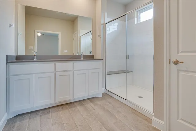 a bathroom with a double vanity sink and mirror