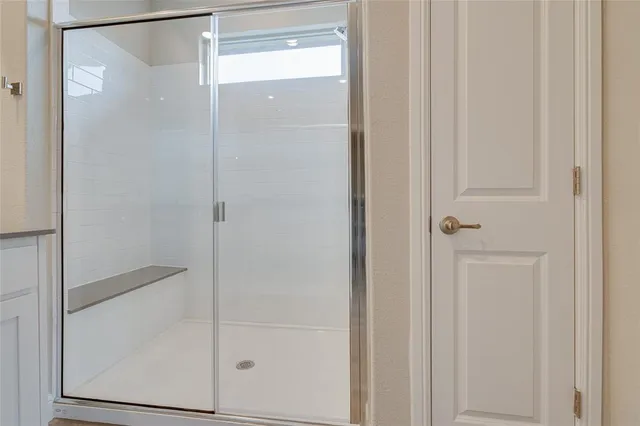 a bathroom with a glass shower door