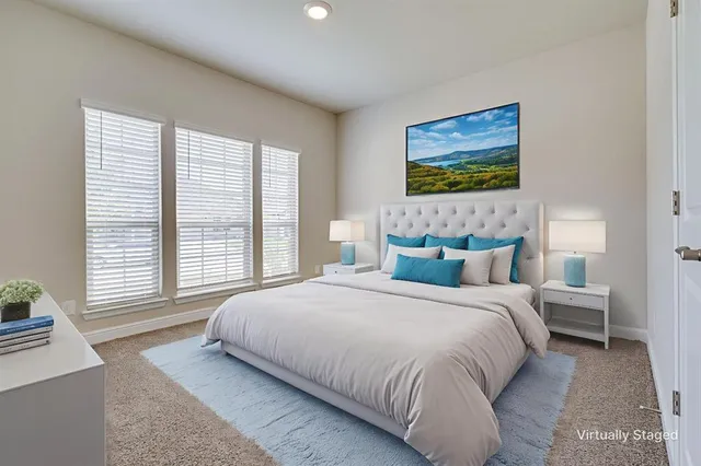 a bedroom with a bed and a large window