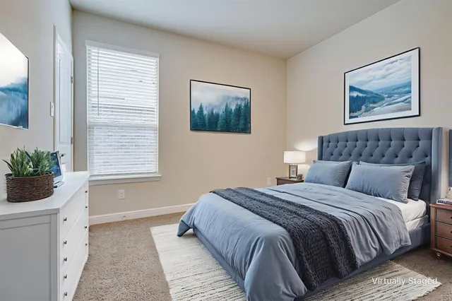 a bedroom with a large bed and a window