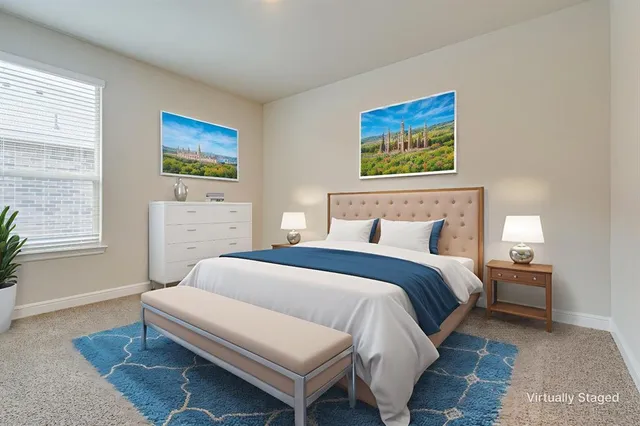 a bedroom with a bed and a painting on the wall