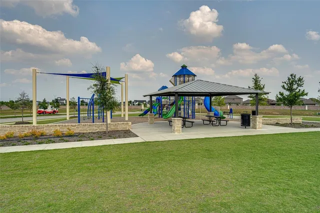 an aerial view of a swimming pool with outdoor seating and yard