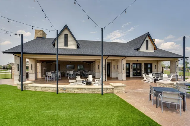 a living room with stainless steel furniture kitchen view and a table
