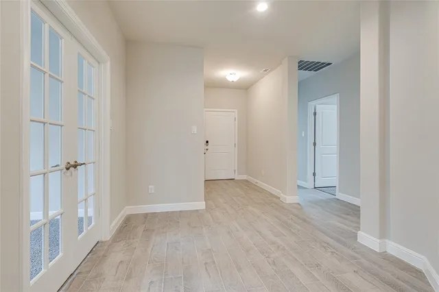a view of an empty room with wooden floor