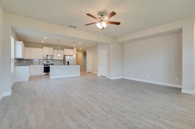 a view of a kitchen with a sink and a stove top oven