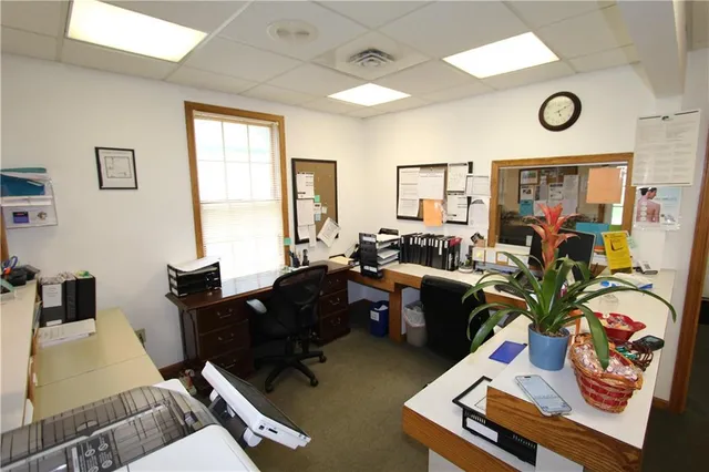 a living room with furniture gym equipment and a window