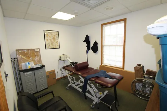 a view of a workspace with furniture and a window
