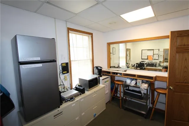 a room with stainless steel appliances a refrigerator a sink and a stove