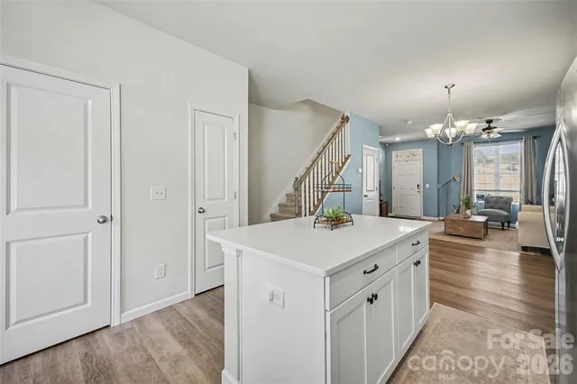a view of a center kitchen island with furniture and wooden floor