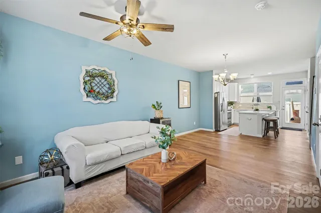 a living room with furniture and kitchen view