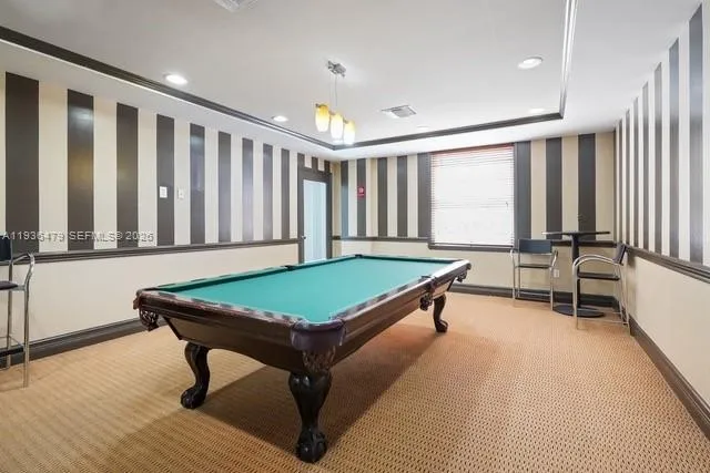 a room with furniture pool table and windows
