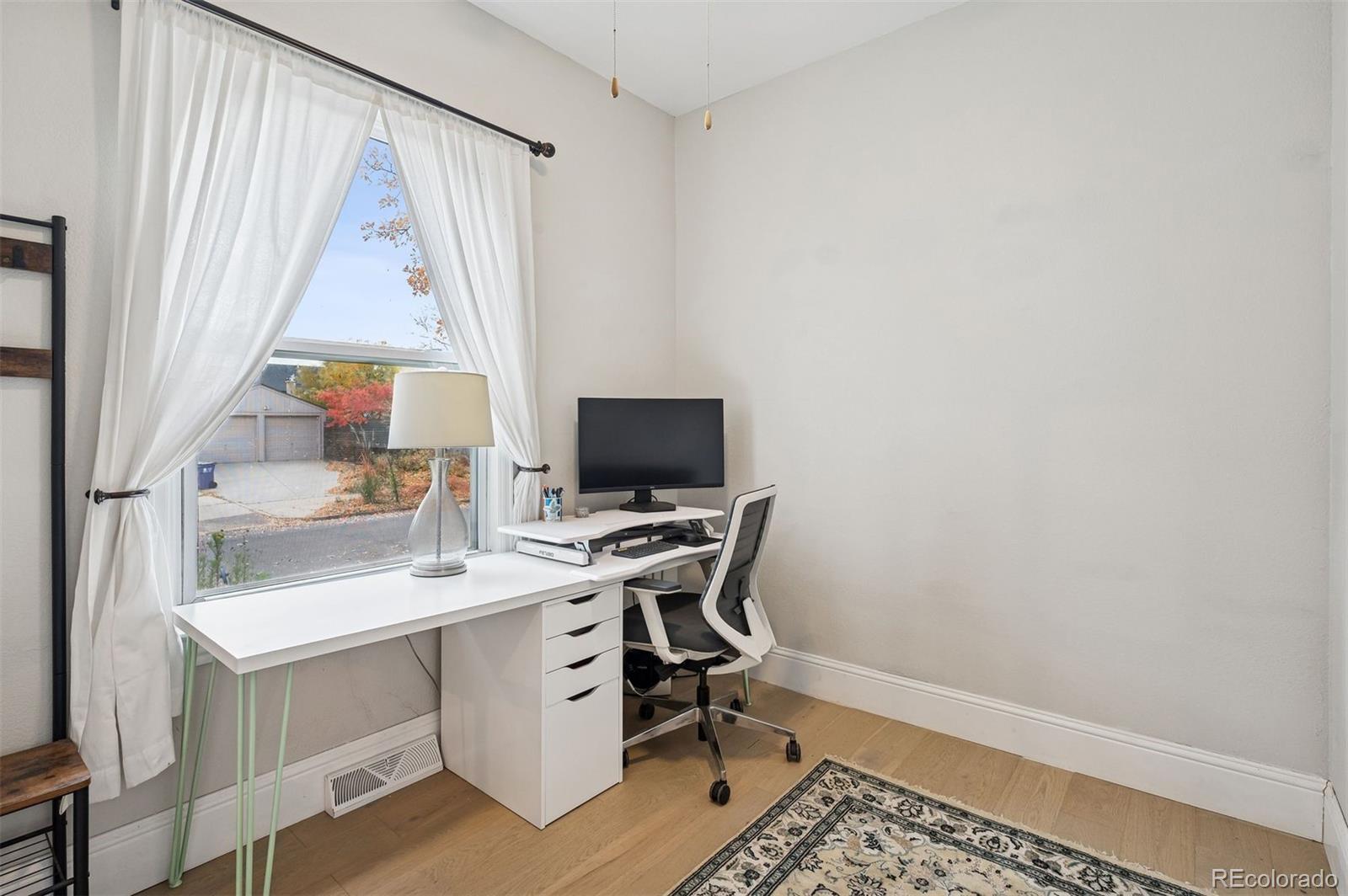 2109 West 41st Avenue Denver, CO 80211 - Photo 12 of 33 a view of a workspace with furniture and a window