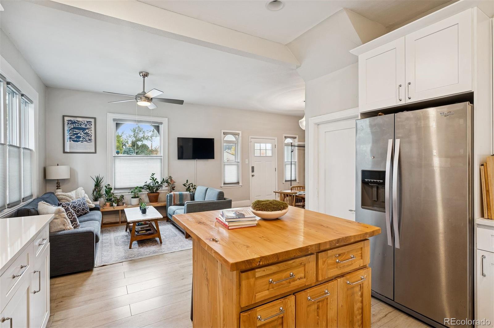 2109 West 41st Avenue Denver, CO 80211 - Photo 15 of 33 a living room with stainless steel appliances kitchen island furniture and a window