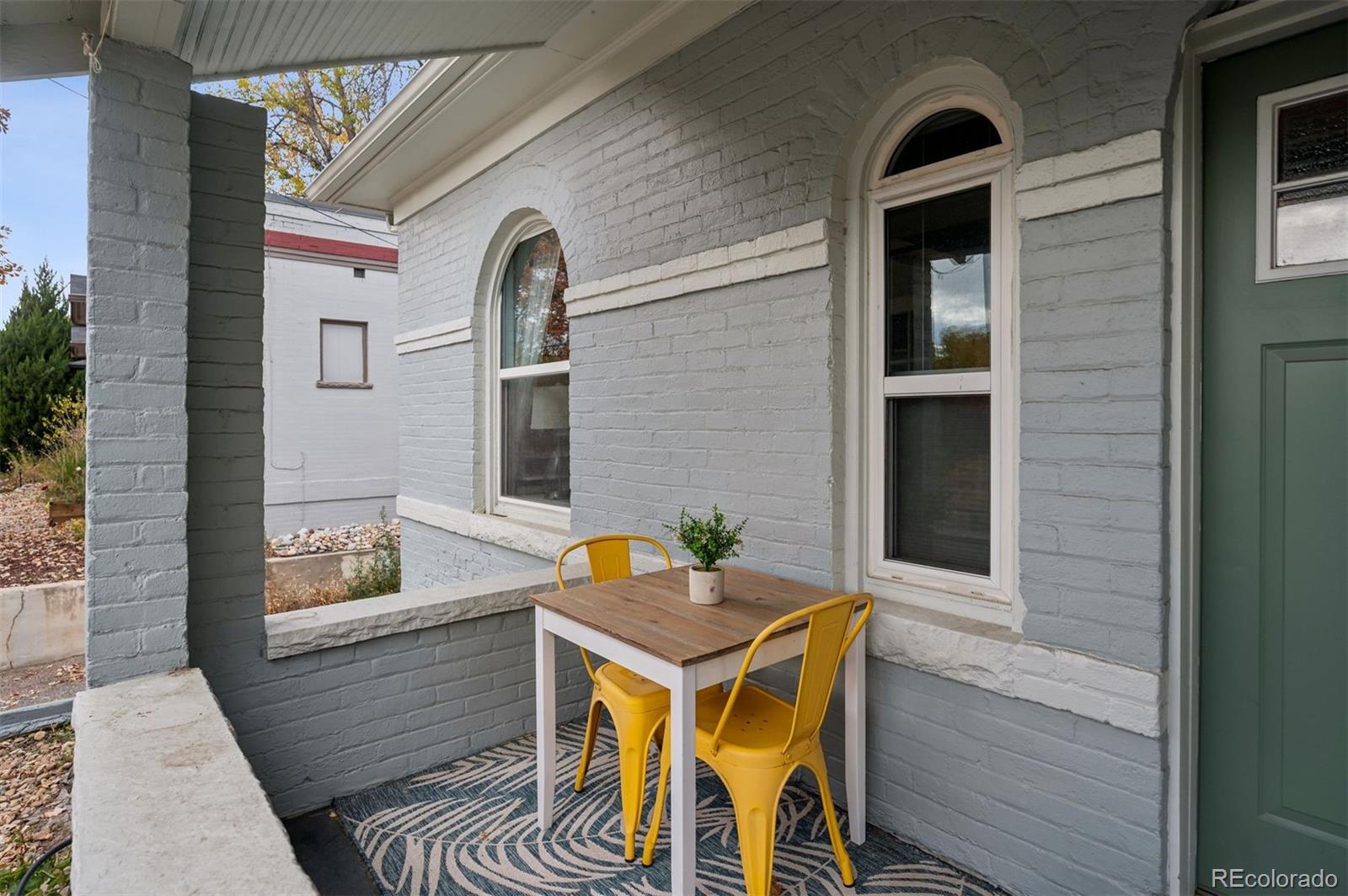 2109 West 41st Avenue Denver, CO 80211 - Photo 22 of 33 a view of a house with a chairs and table in a balcony