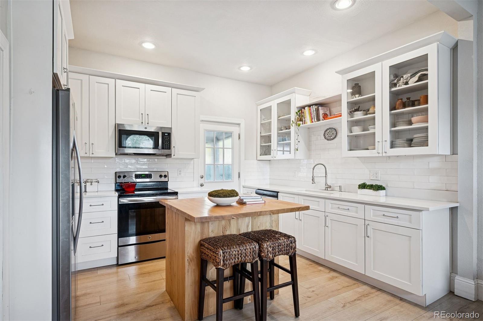 2109 West 41st Avenue Denver, CO 80211 - Photo 7 of 33 a kitchen with a sink stove and microwave