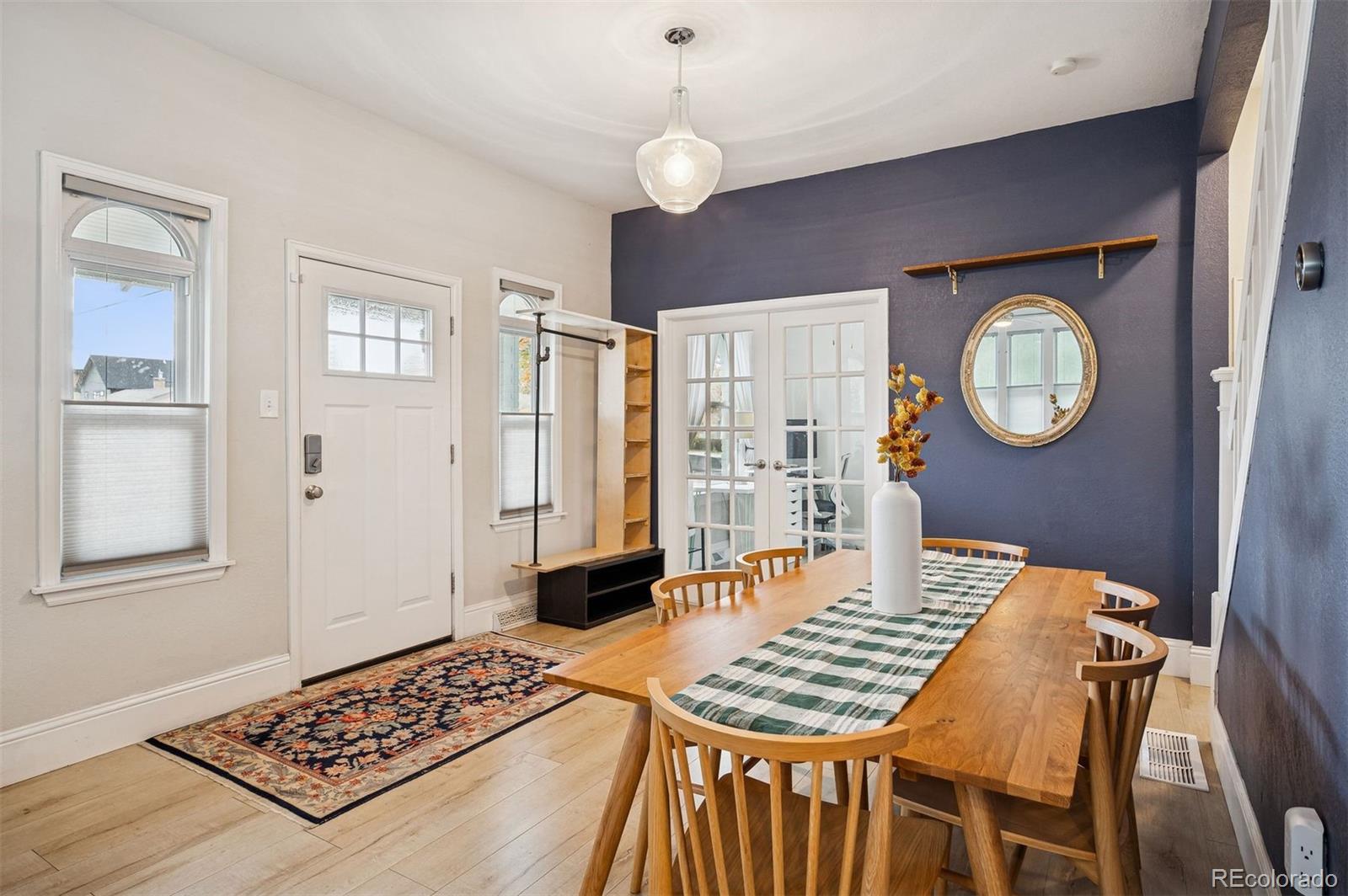 2109 West 41st Avenue Denver, CO 80211 - Photo 10 of 33 a view of a dining room with furniture and a chandelier