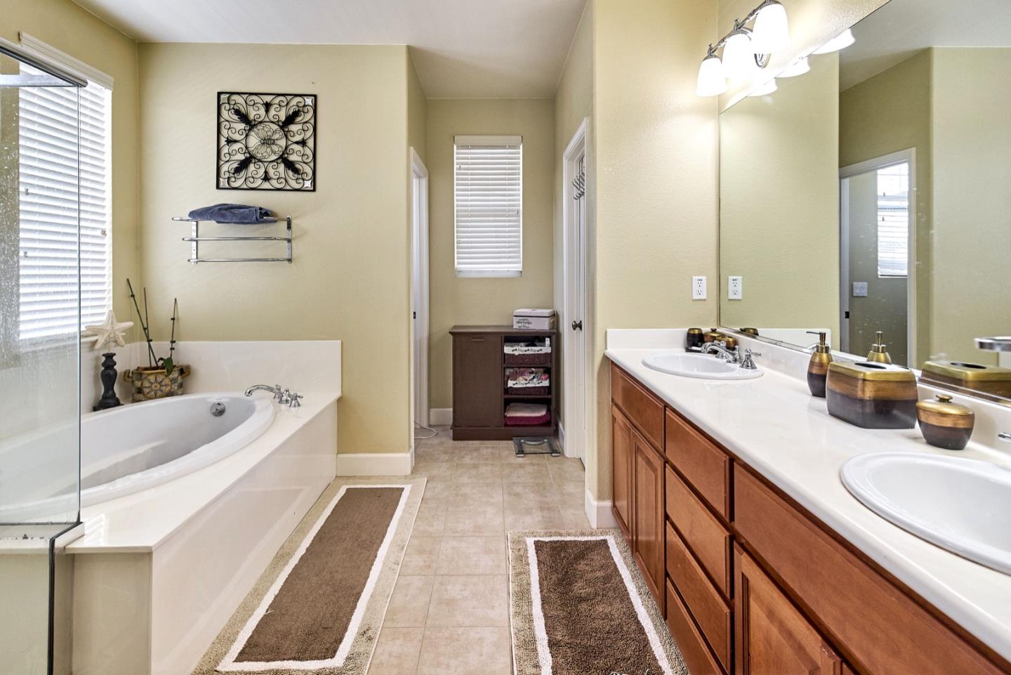 1570 Reston Terrace Sunnyvale, CA 94087 - Photo 21 of 39 a spacious bathroom with double vanity sinks a large mirror and a bathtub