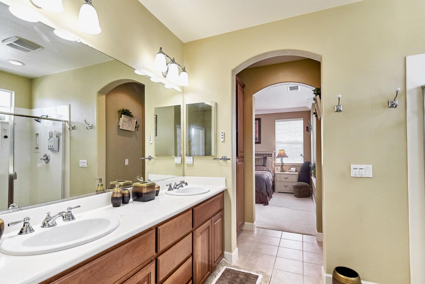 1570 Reston Terrace Sunnyvale, CA 94087 - Photo 24 of 39 a en suite bathroom with a double vanity sink and a mirror