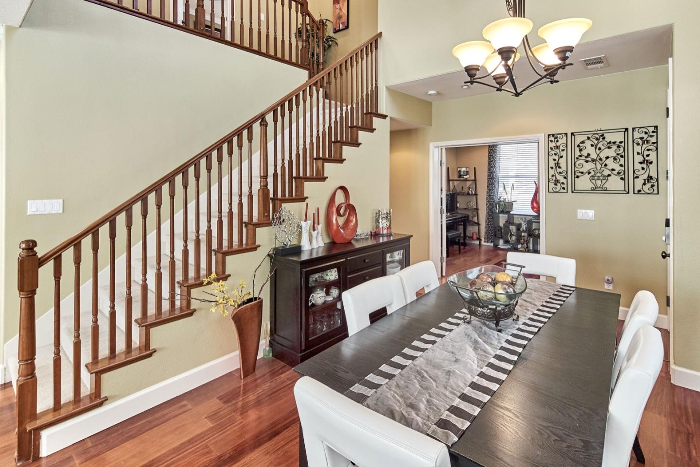 1570 Reston Terrace Sunnyvale, CA 94087 - Photo 4 of 39 a view of a dining room with furniture a chandelier and wooden floor