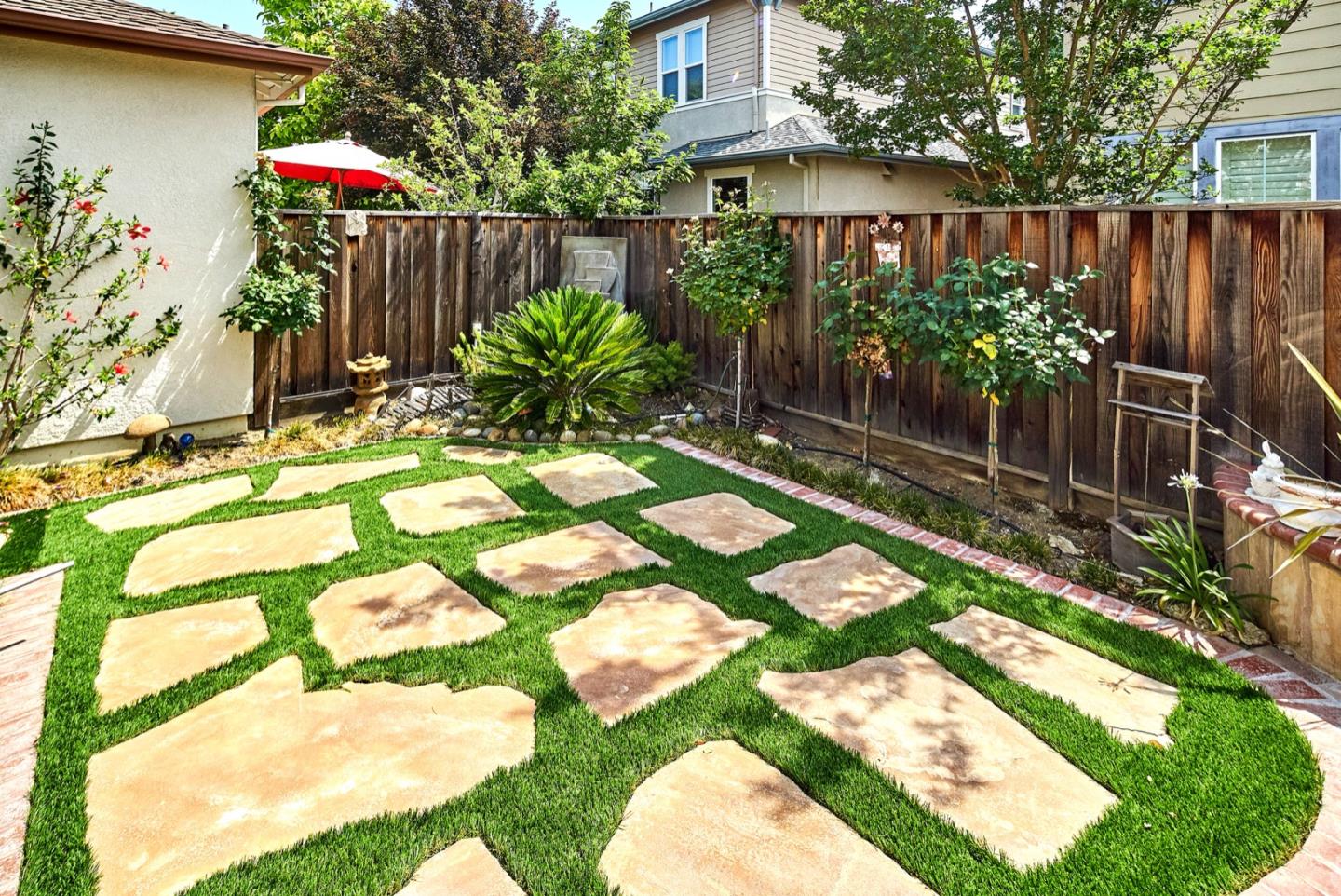 1570 Reston Terrace Sunnyvale, CA 94087 - Photo 38 of 39 a backyard of a house with lots of green space and glass windows