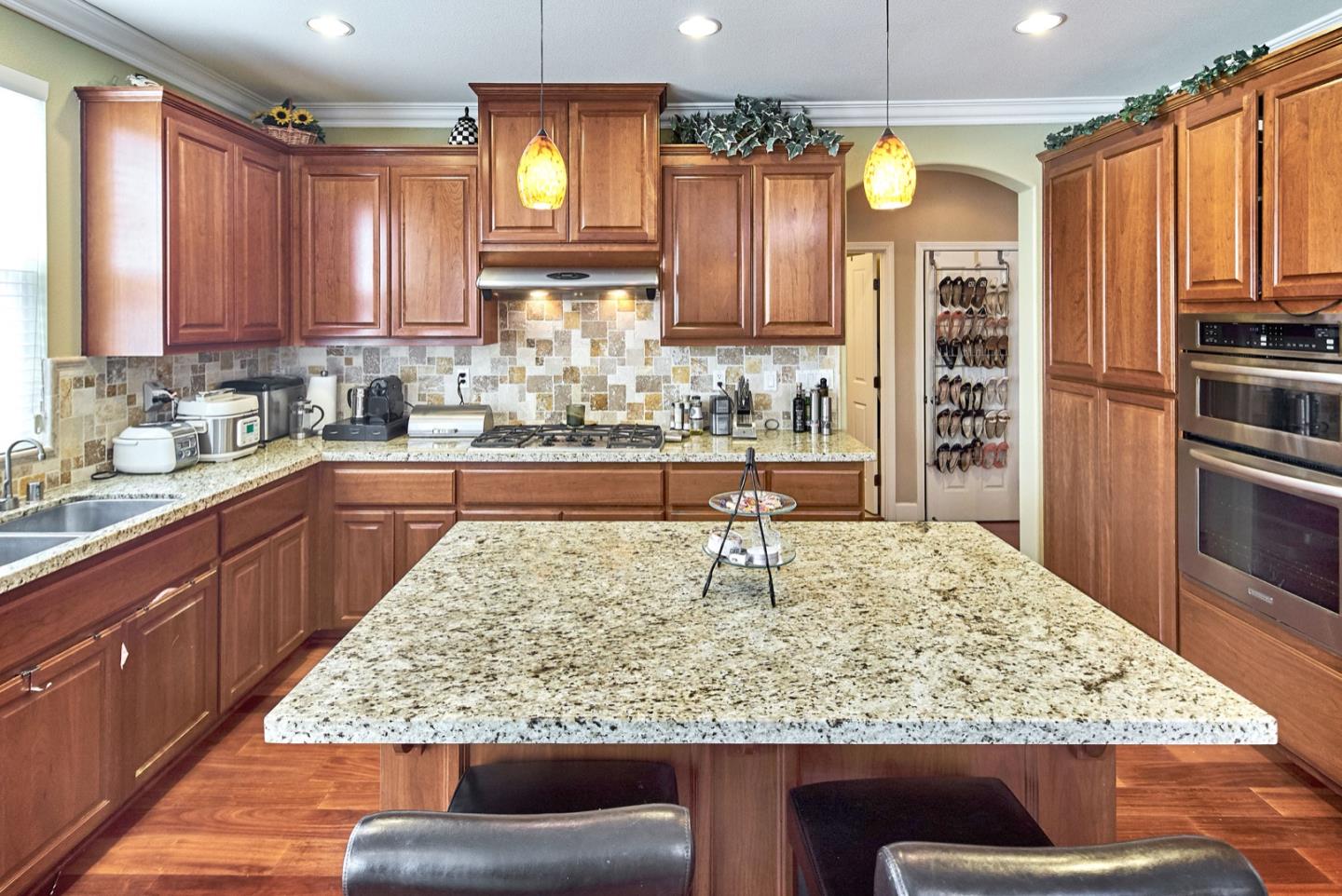 1570 Reston Terrace Sunnyvale, CA 94087 - Photo 9 of 39 a large kitchen with kitchen island granite countertop wooden cabinets a granite counter and a sink
