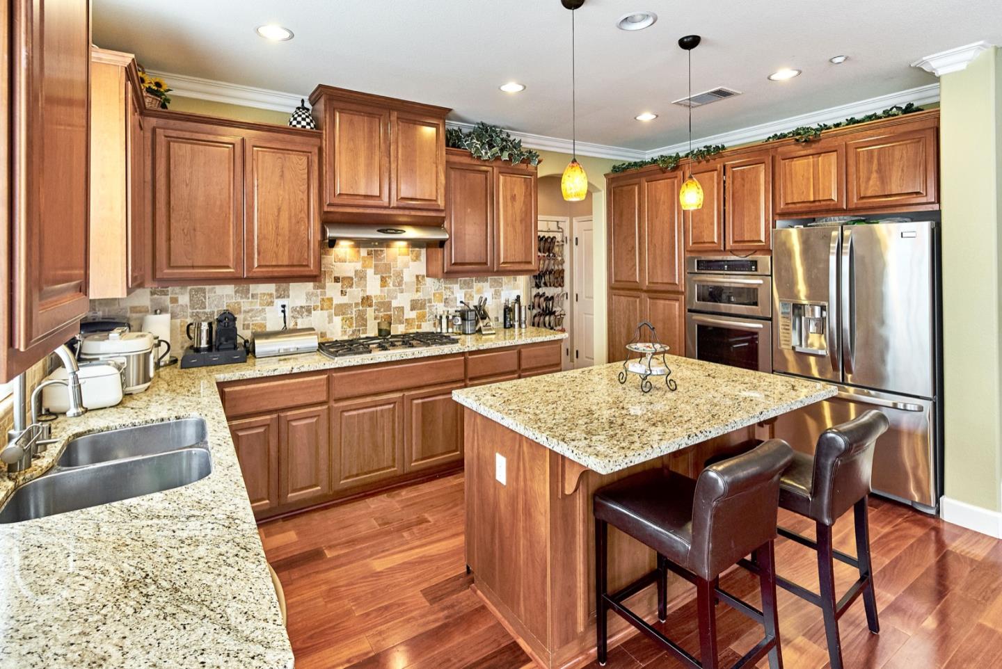 1570 Reston Terrace Sunnyvale, CA 94087 - Photo 10 of 39 a kitchen with stainless steel appliances granite countertop a sink refrigerator and cabinets