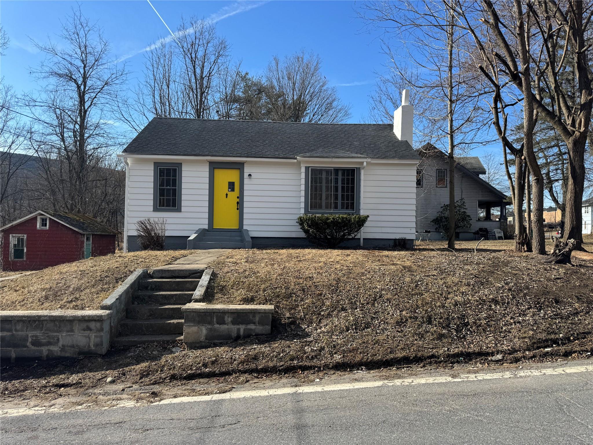 6 Institution Road Napanoch, NY 12458 - Photo 1 of 1 View of front of house with a shingled roof, an outdoor structure, a chimney, and entry steps