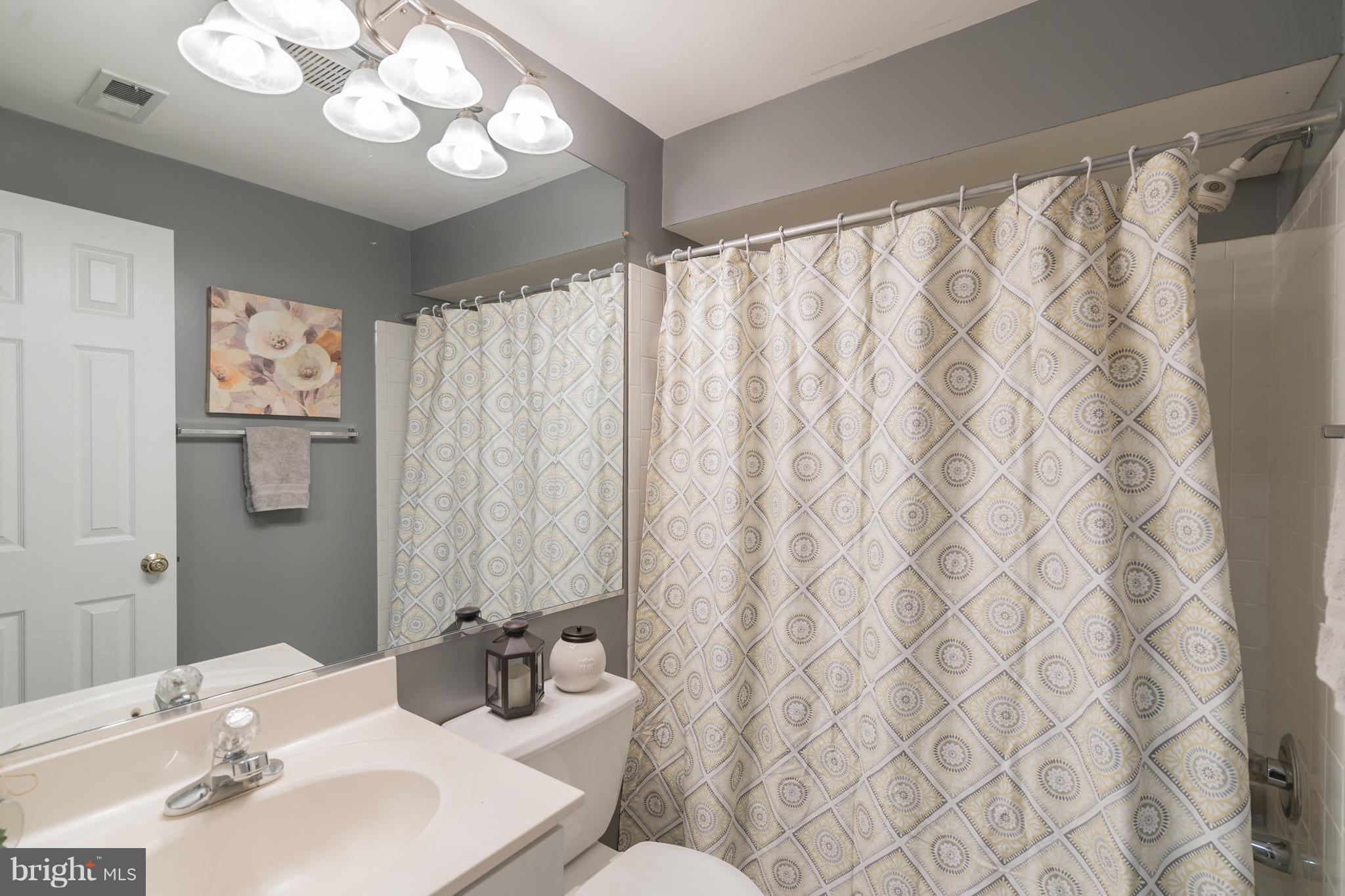 11459 Heritage Commons Way Reston, VA 20194 - Photo 12 of 30 a bathroom with a sink and a mirror