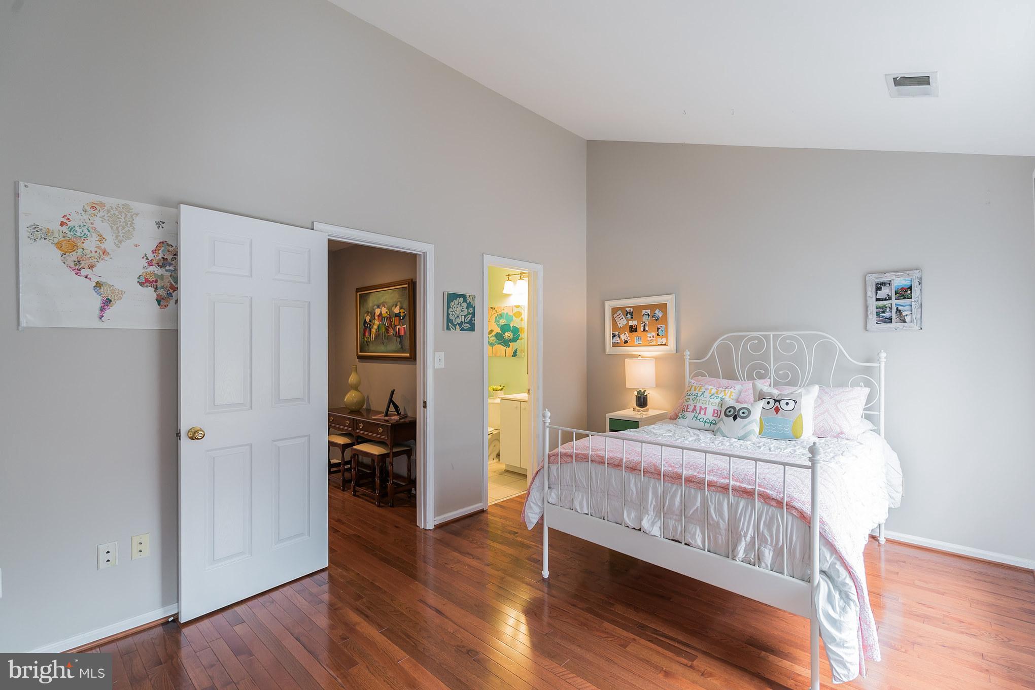 11459 Heritage Commons Way Reston, VA 20194 - Photo 13 of 30 a bedroom with a bed and wooden floor