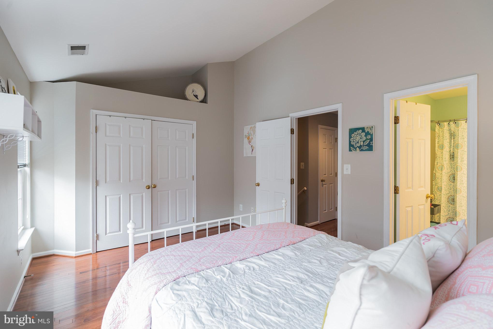 11459 Heritage Commons Way Reston, VA 20194 - Photo 15 of 30 a bedroom with a bed and wooden floor