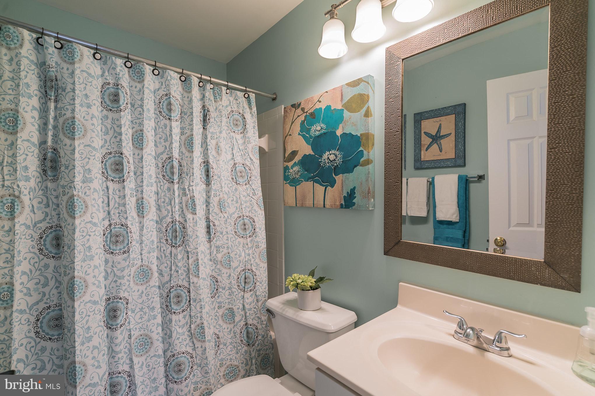 11459 Heritage Commons Way Reston, VA 20194 - Photo 16 of 30 a bathroom with a sink mirror and toilet