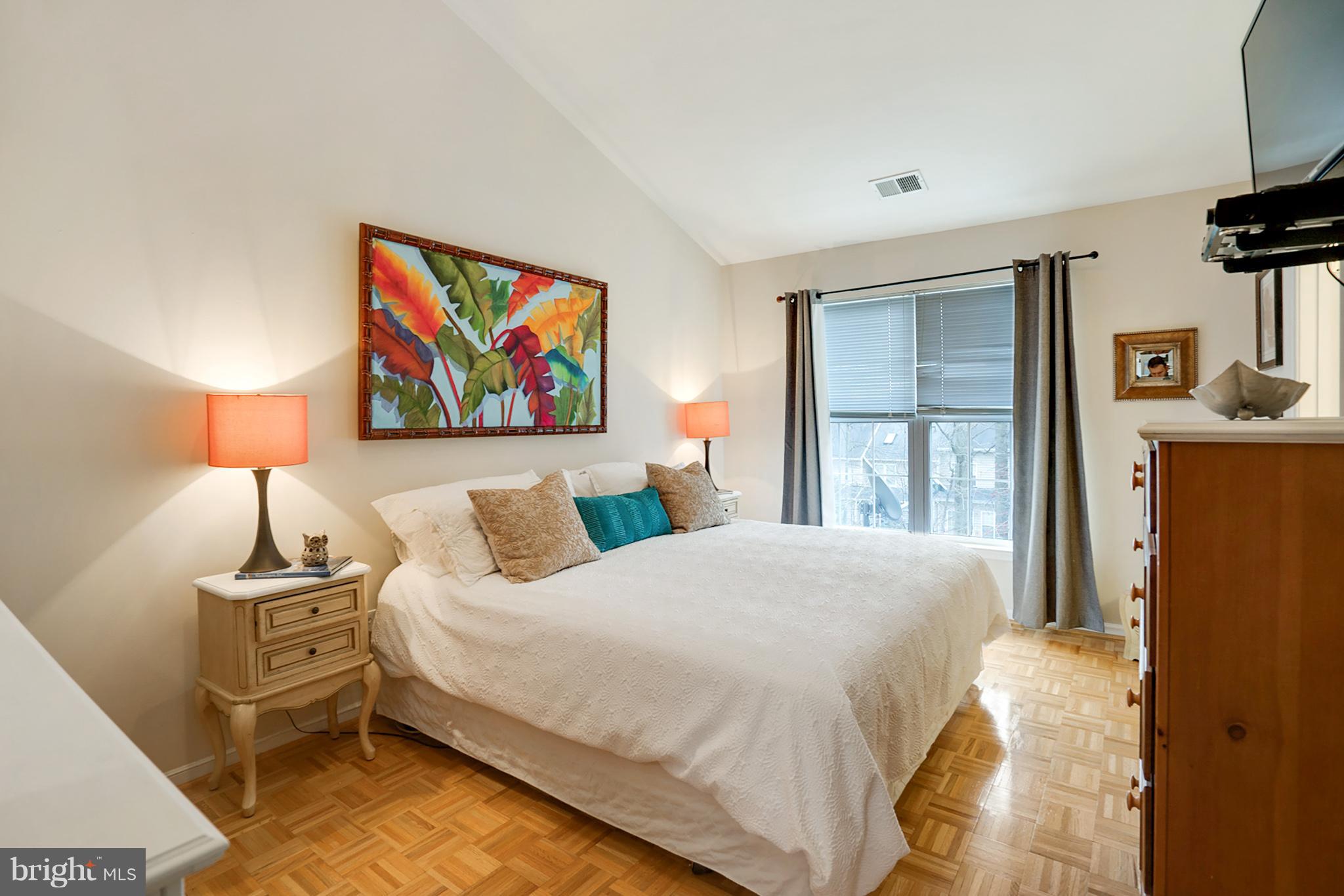 11459 Heritage Commons Way Reston, VA 20194 - Photo 18 of 30 a bedroom with a bed and a lamp on table